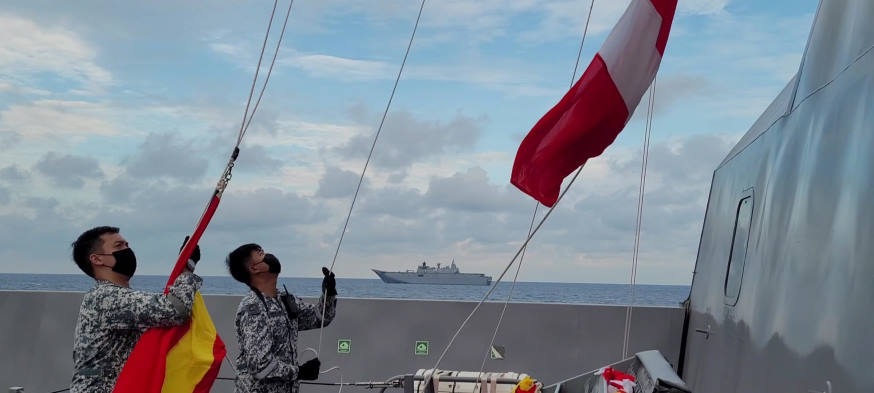 Signal flags being hoisted to exchange messages during a communication exercise.