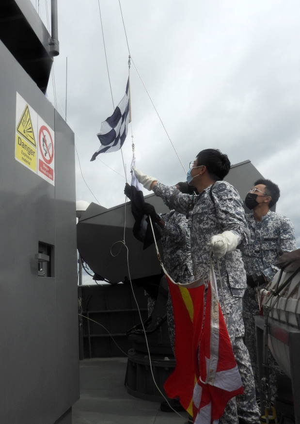 Communication System Operators preparing flags as part of an encoded message during a communication exercise. To build interoperability, the ships conducted communication and manoeuvring exercises during the PASSEX.