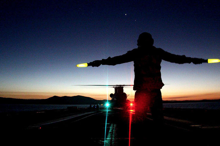 Seahawk helicopter landing at night on a Navy Ship