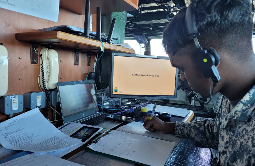 Personnel from RSS Tenacious listening to a radio message sent by their Indonesian counterpart during a communications drill.
