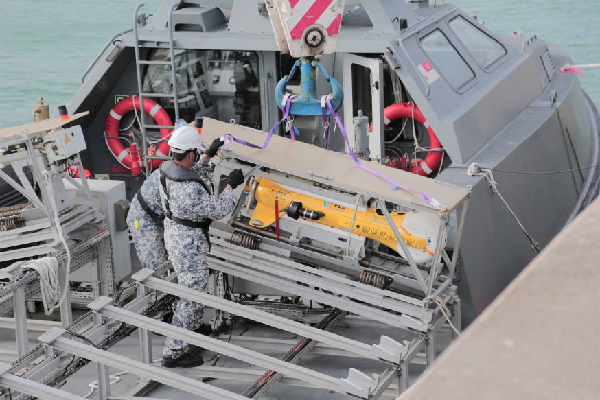 Loading the K-STER expendable mine disposal system on to the unmanned surface vessel.