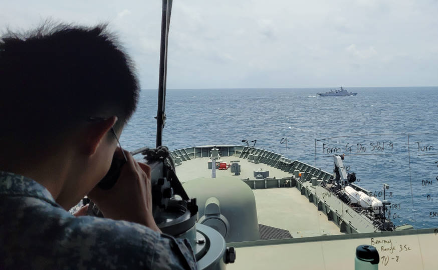 Crew member of RSS Endeavour taking bearing from KRI Diponegoro as part of the manoeuvring exercise.