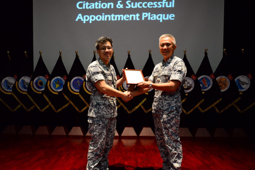 Commander NALCOM ME7 Khoo (left) presents the citation and successful appointment plaque to outgoing Master Chief NALCOM ME5 Chan as a recognition of his dedication and contributions to NALCOM.