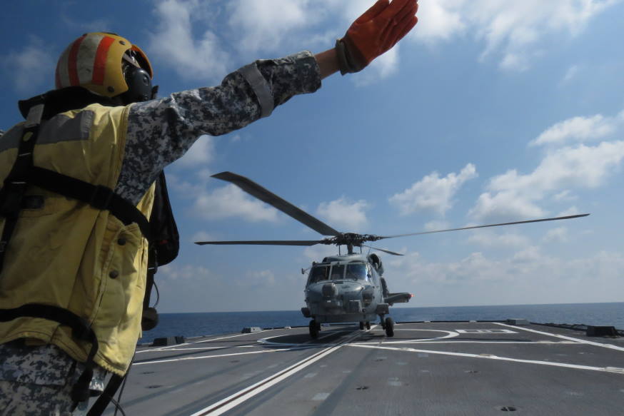 Our flight deck marshaller sending the signal for HMAS Anzac's MH-60R helicopter to land on RSS Stalwart.