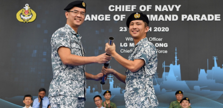 Outgoing Chief of Navy, RADM Lew (left), handing over the command symbol to incoming Chief of Navy, RADM Aaron Beng (right).