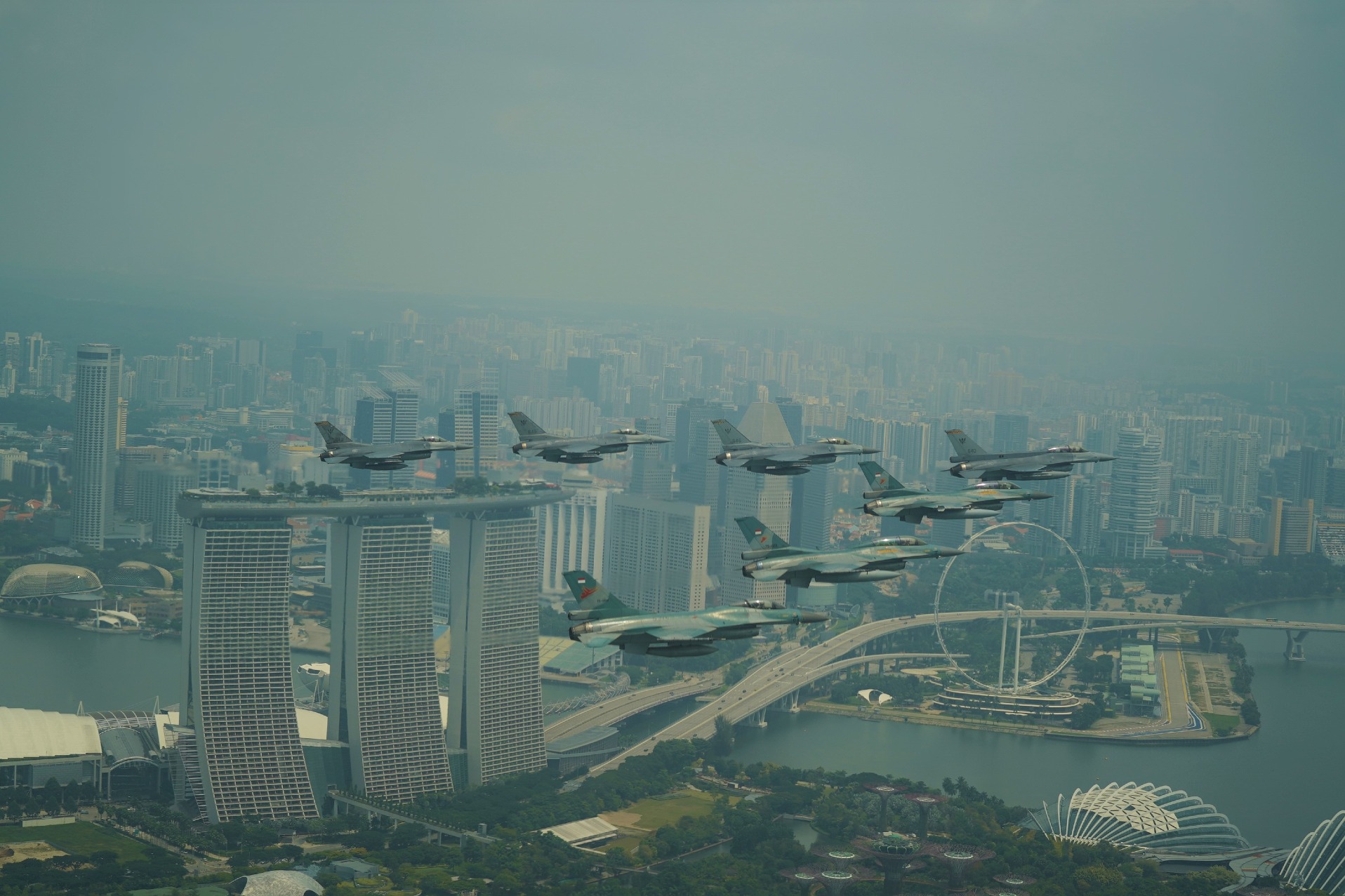 The Republic of Singapore Air Force (RSAF) and the Indonesian Air Force (TNI AU)'s F-16 aircraft flying in formation over Marina Bay Sands in Singapore.